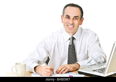 Happy office worker reviewing generic reports at his desk Stock Photo