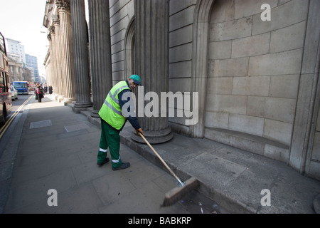 Sweeping up outside the bank of england street cleaner cleaning pavement outside the Bank of england City of London Stock Photo