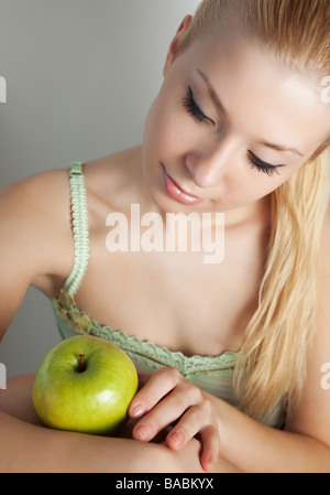 Young attractive blonde with green apple Stock Photo