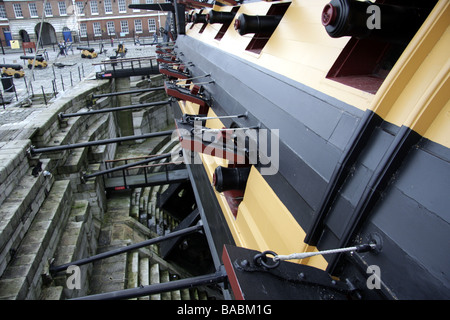 Cannons poking through gun ports on HMS Victory at the Royal Navy Historic Dockyard in Portsmouth Stock Photo