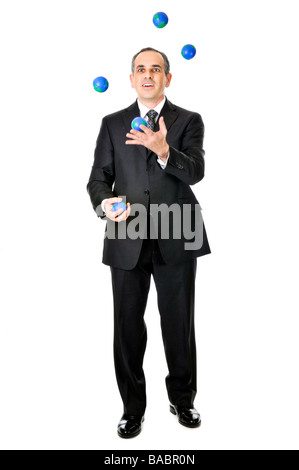 Business man in suit juggling planet earth balls Stock Photo