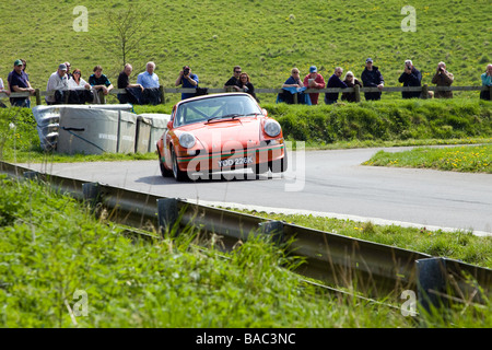 Classic Porsche 911 lifting a wheel while cornering hard at Gurston Down hill climb Stock Photo