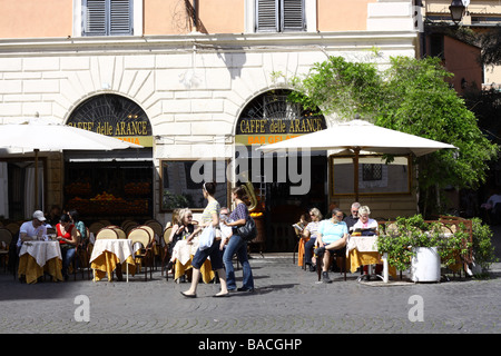Tourists at a bar on Santa Maria in Trastevere square, Rome, Italy. Stock Photo