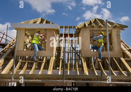 Carpenters working on the roof of a new house. Stock Photo