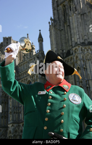 City of Wells, England. Close up view of Wells Town Crier Len Sweales, with Wells Cathedral in the background. Stock Photo