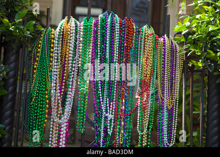 New Orleans Louisiana Mardi Gras beads on the gate of a house in the Garden District Stock Photo