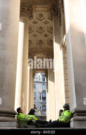Police rest in front of The Bank Of England during the G20 protests Stock Photo