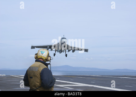 EA 6B Prowler practicing on USS Abraham Lincoln out of homeport, Everett, Washington with Navy crew member standing by Stock Photo