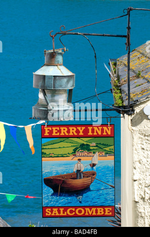 Pub sign outside Ferry Inn pub in an alleyway going down  to the Salcombe passenger ferry with the sea as a background.  Salcombe, Devon, England,UK Stock Photo