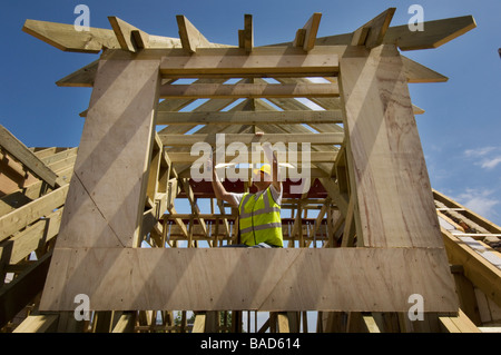 A roofer at work on a new house with dormer windows Stock Photo