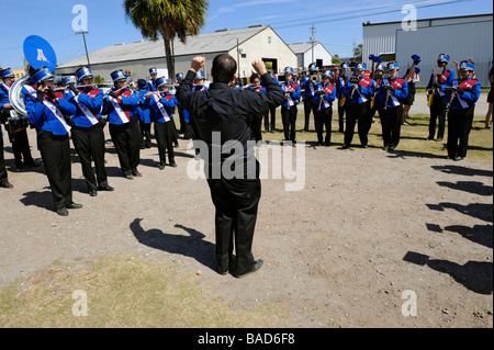 High School Band Members practice with band director at Strawberry Festival Parade Plant City Florida Stock Photo