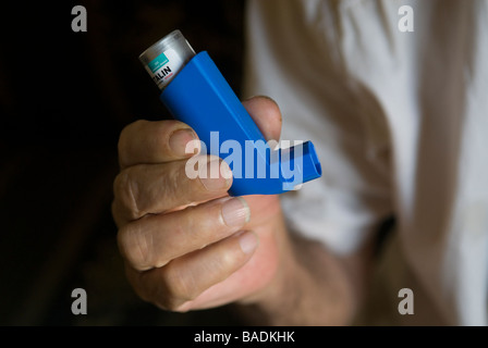 Old man holding an inhaler Stock Photo