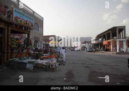 Street scene in Dahab Egypt showing typical shop fronts from the old traditional butchers to the modern mobile phone store Stock Photo