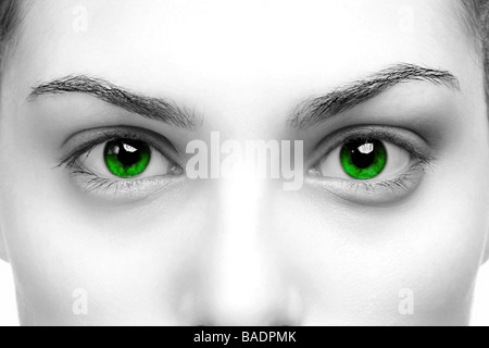High contrast black white close up of a womans eyes coloured green Stock Photo