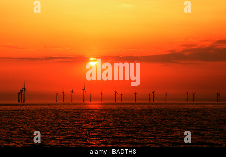 The Wind farm outside of Liverpool with setting sun over the Irish Sea Stock Photo