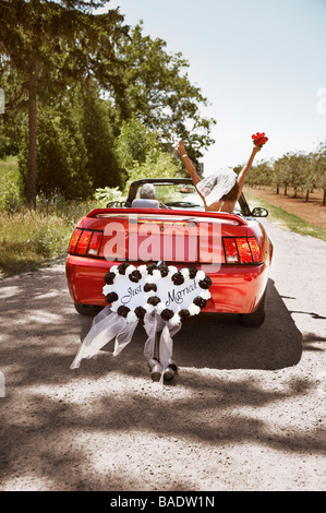 Newlyweds Driving Away in Convertible, Niagara Falls, Ontario, Canada Stock Photo