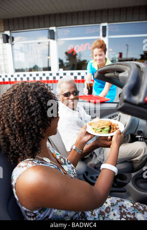 Waitress Serving Couple in Their Convertible at a Retro Diner, Niagara Falls, Ontario, Canada Stock Photo