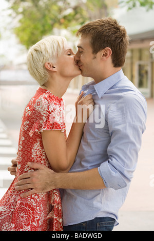 Young Couple Kissing Outdoors Stock Photo