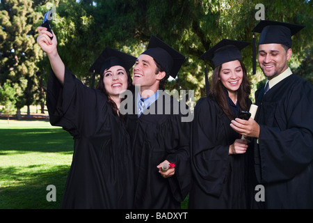 College Graduates with Cellular Phones Stock Photo