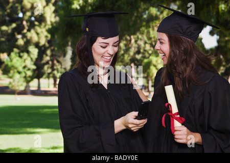 Graduates with Cellular Phone Stock Photo