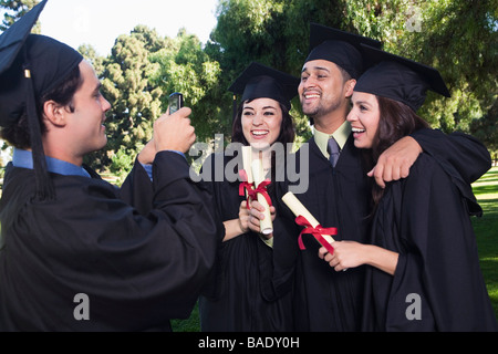 College Graduates Posing for Photograph Stock Photo
