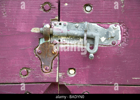 Close-Up of Sliding Bolt Lock on Purple Gate Stock Photo