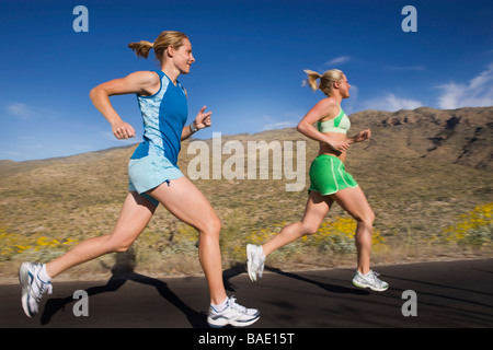 Woman Running on Paved Road, Saguaro National Park, Tucson, Arizona,USA Stock Photo