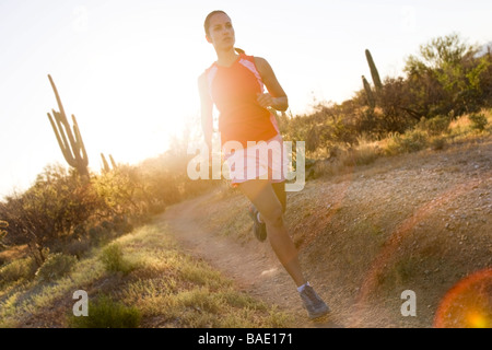 Woman Running on  Desert Trail, Saguaro National Park, Arizona, USA Stock Photo