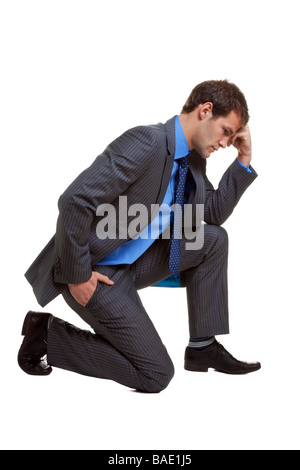 Image of a businessman in a pose known as The Thinker isolated on white background with slight shadow at contact points Stock Photo