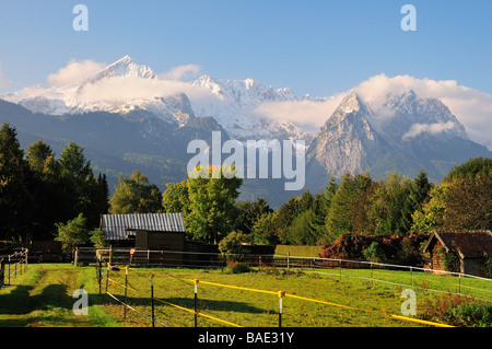 Farm by Mountains, Alpspitze, Garmisch-Partenkirchen, Bavaria, Germany Stock Photo