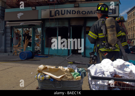 FDNY firefighters at an all hands fire in a laundromat in Harlem in New York Stock Photo