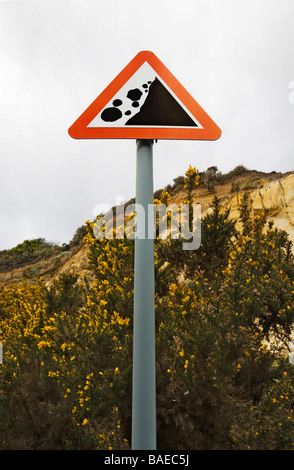 A sign on Bournemouth beach, at the base of the cliff, warning of the danger of rock fall due to coastal erosion. Dorset. UK Stock Photo