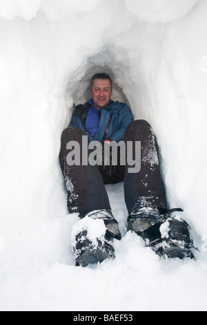A group of mountaineers building snow holes on Cairngorm in the Cairngorm National Park in Scotland UK Stock Photo