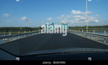 A car on its way over a bridge. Stock Photo