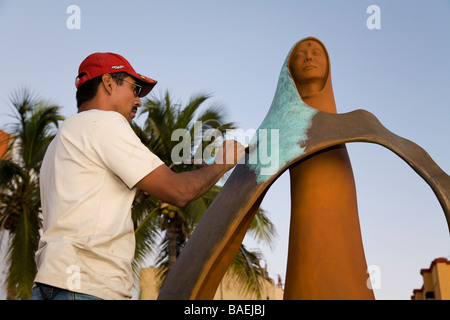 MEXICO La Paz Artist Rocio Sanchez use blow torch to apply finish to bronze sculpture La Reina del Mar the Queen of the Sea Stock Photo
