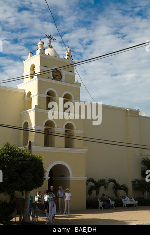 MEXICO Todos Santos Bell tower and entrance to Mission of Santa Rosa de Todos Santos church tourists walking outside building Stock Photo