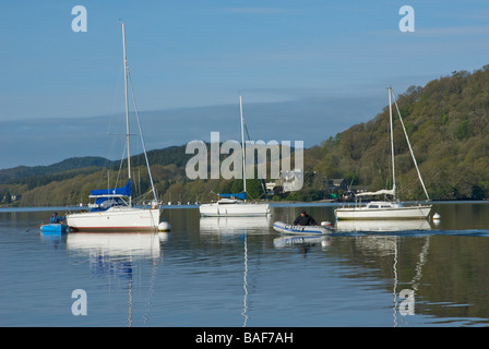 One man in tender, another in inflatable dinghy, Lake Windermere, Lake District National Park, Cumbria, England UK Stock Photo