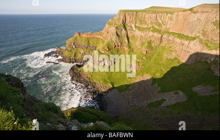 Giant's Cove. A small wave swept cove below the red basalt columns that form the Giant's Causeway. Stock Photo