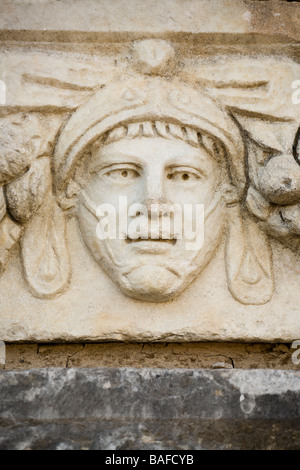 Soldier or Gladiator. A helmeted face is depicted in this carving from the artist colony and school  collected at Aphrodisias Stock Photo