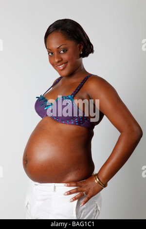 pretty black girl heavily pregnant  showing off  her belly Stock Photo