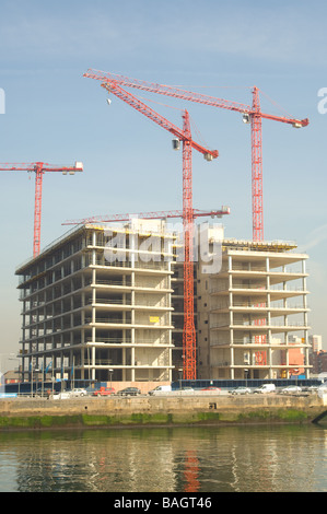 Red construction cranes at high rise development in Dublin on river Liffey waterfront, Dublin, Ireland Stock Photo