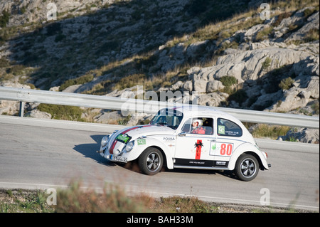 White 1965 Volkswagen Beetle classic car racing in the Classic car rally Mallorca Stock Photo