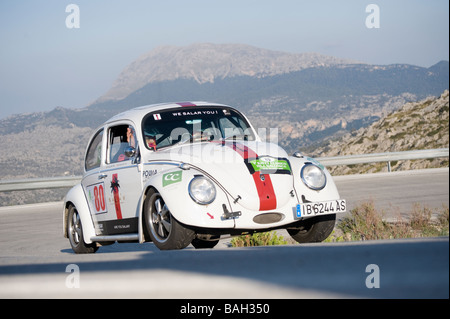 White 1965 Volkswagen Beetle classic car racing in the Classic car rally Mallorca Stock Photo