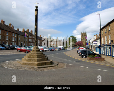 Market Cross and the church of St Gregory North End Bedale North Yorkshire UK Stock Photo