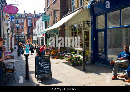 Spring London Hampstead Village Flask Walk mews lane typical old English sidewalk pavement pub public house bar cafe cafes shop shops smokers Stock Photo