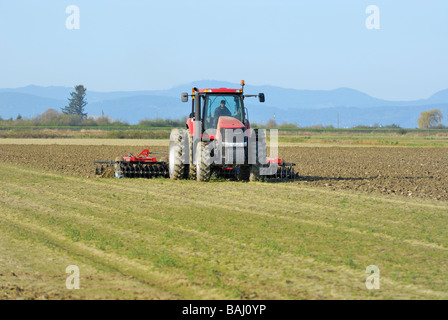 Farmer Disk Ripping a field, preparing it for planting. Stock Photo