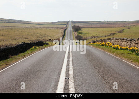 Long straight quiet empty country road route across Northumberland National Park. England UK Britain. Stock Photo