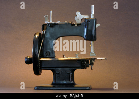 A vintage sewing machine against a black background Stock Photo