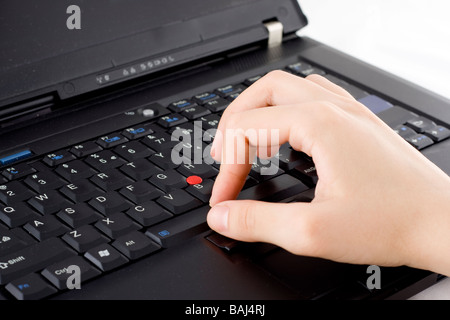 Typing with right hand on a black laptop Stock Photo