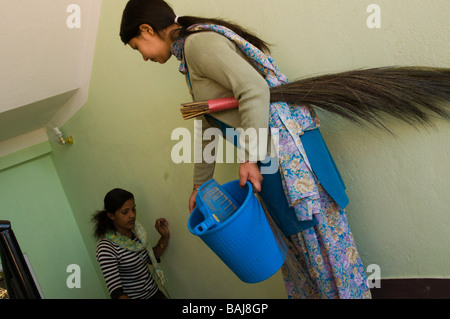 nepali girls cleaning and sweeping Stock Photo